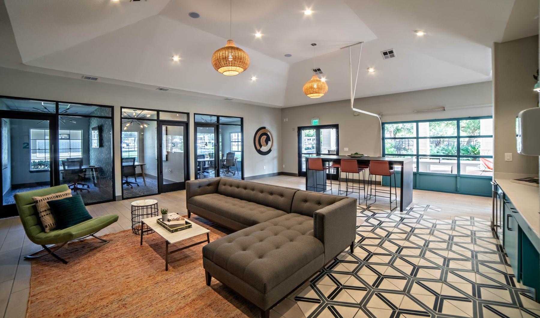 Find your perfect fit at Village at East Riverside a large living room with a large glass wall and a large glass door